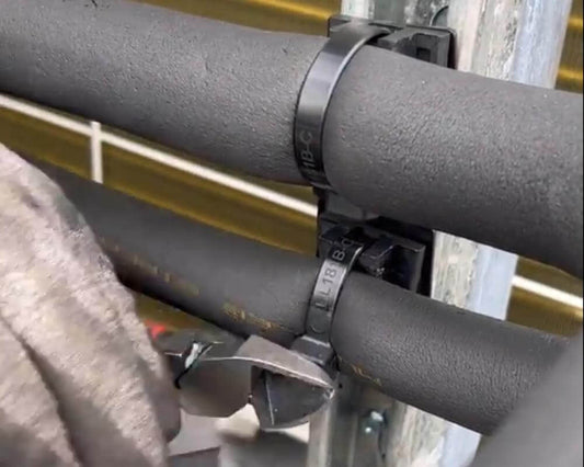 Removing a clamp from a pipe in a unistrut 